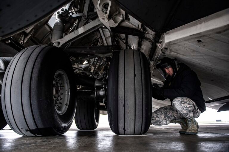 Senior Airman Zachary Anderson, 911th Aircraft Maintenance Squadron crew chief, checks the air pressure of a tire on a C-17 Globemaster III at the Pittsburgh International Airport Air Reserve Station, Pa., May 6, 2020.jpg