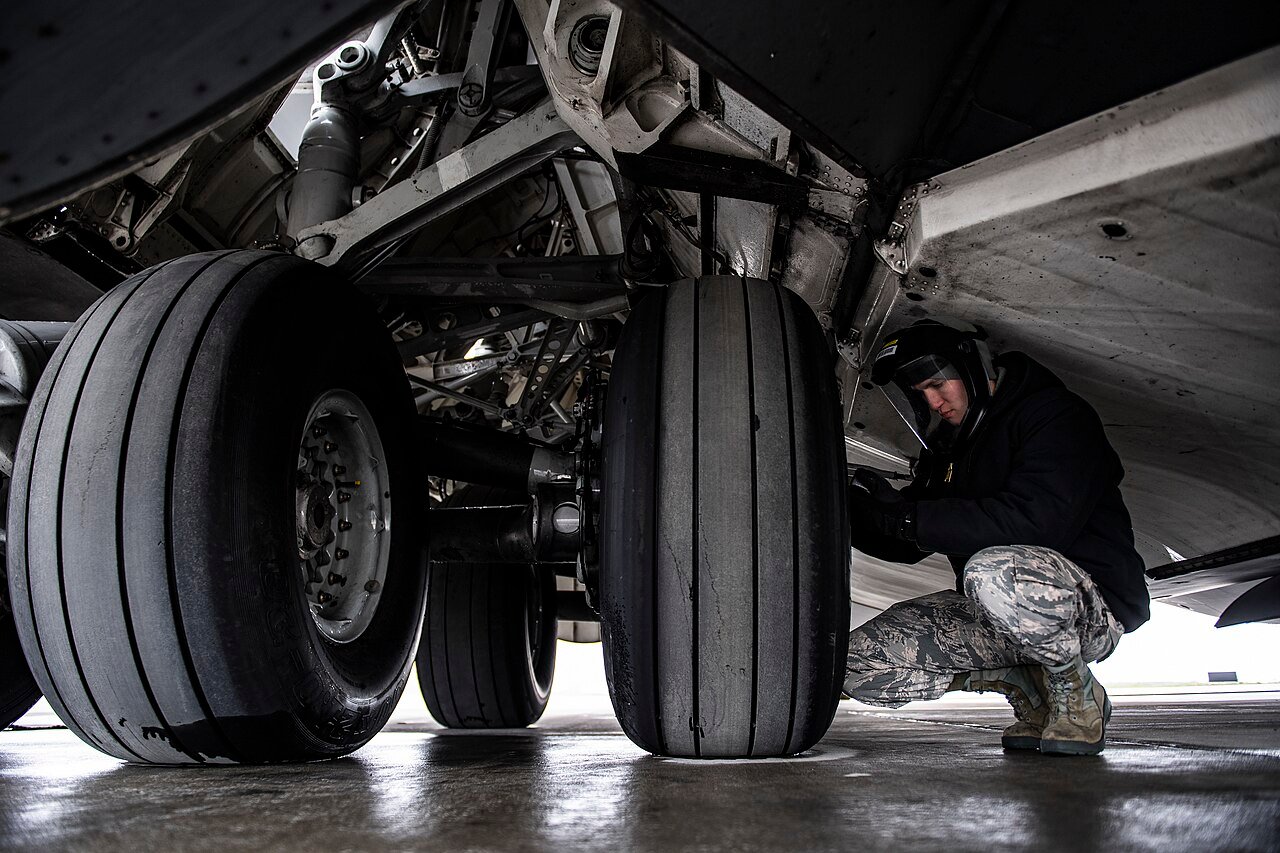 Senior Airman Zachary Anderson, 911th Aircraft Maintenance Squadron crew chief, checks the air pressure of a tire on a C-17 Globemaster III at the Pittsburgh International Airport Air Reserve Station, Pa., May 6, 2020.jpg